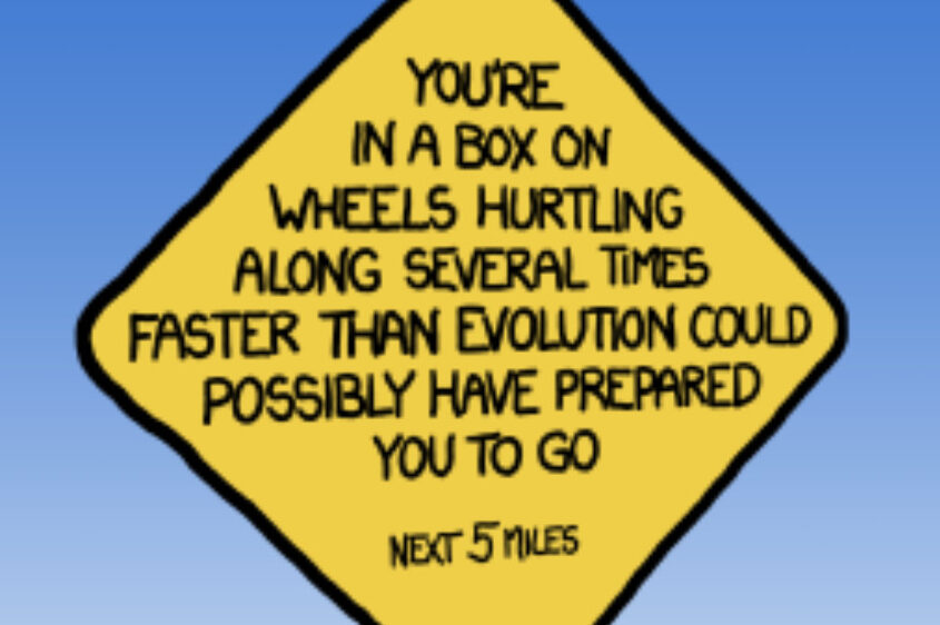 Image of traffic sign labeled 'You're in a box on wheels hurtling along several times faster than evolution could possibly have prepared you to go'